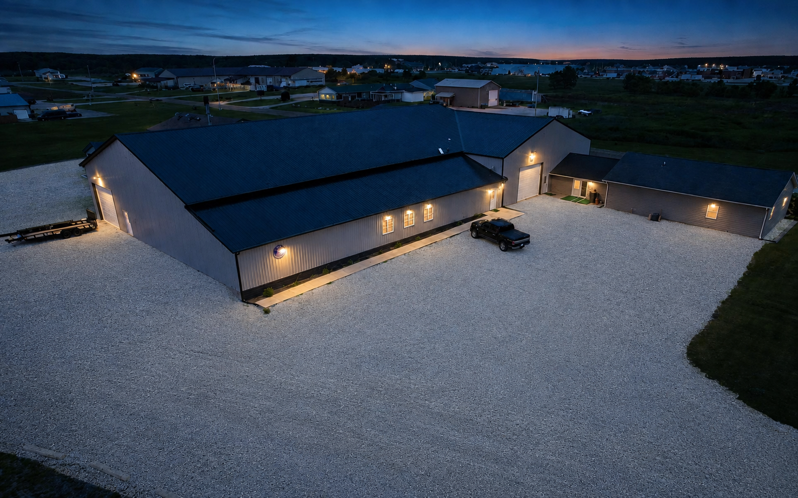 T3 Estate aerial dusk view of exterior grounds and parking